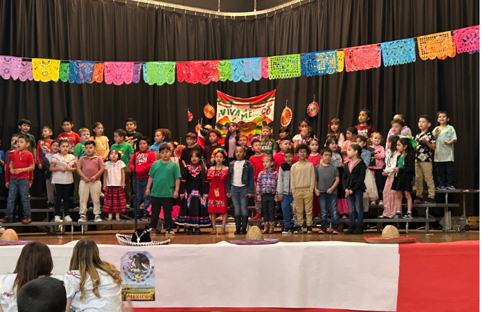  Students performing on stage with Cinco De Mayo decorations